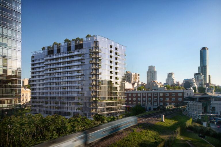 Vista aérea de un desarrollo urbano moderno integrado con áreas verdes en una ciudad.