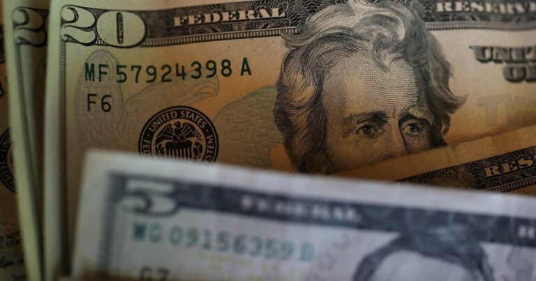 Billetes de dólar y pesos argentinos sobre una mesa