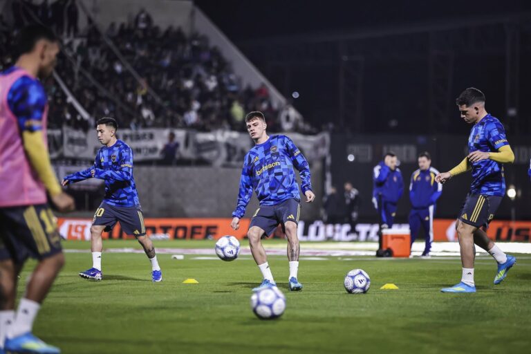 Jugadores de Boca Juniors y Deportivo Riestra en el campo de juego del estadio Guillermo Laza